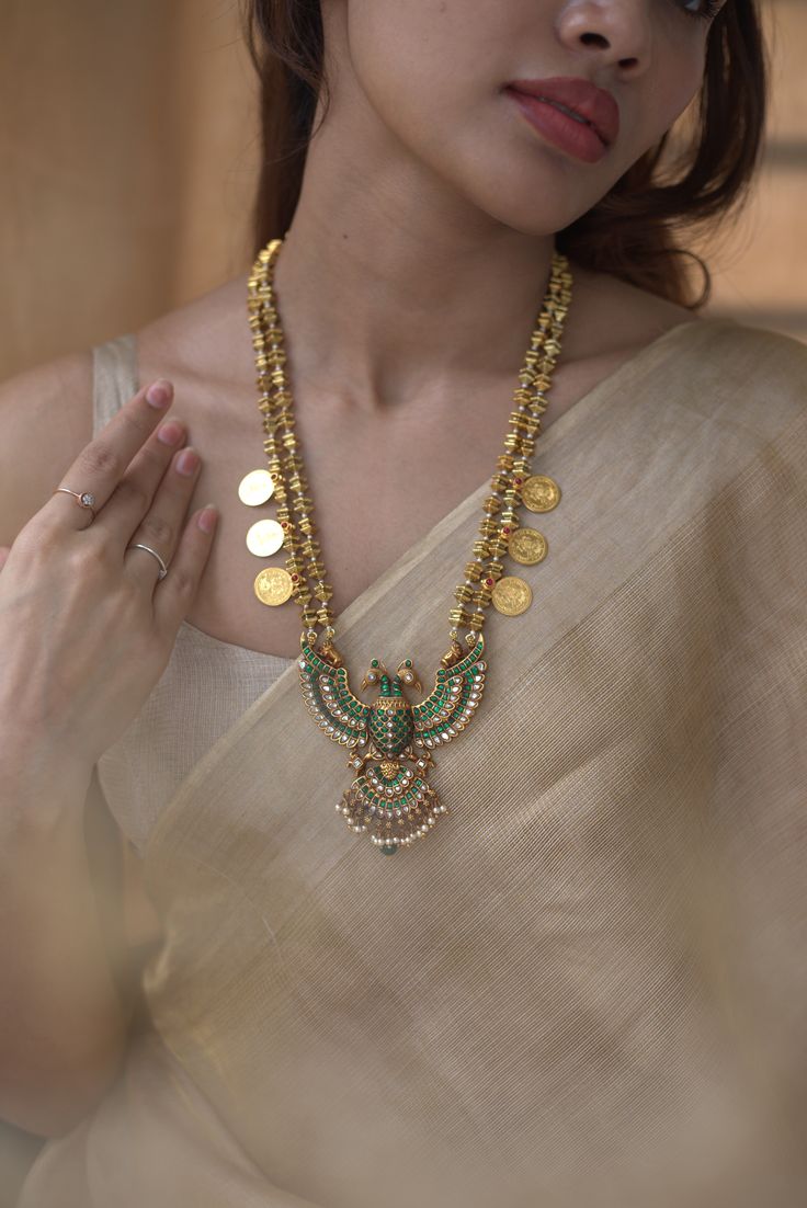 ANTIQUE GOLD NECKLACE WITH BIRD DESIGN AND COIN PENDANTS.
