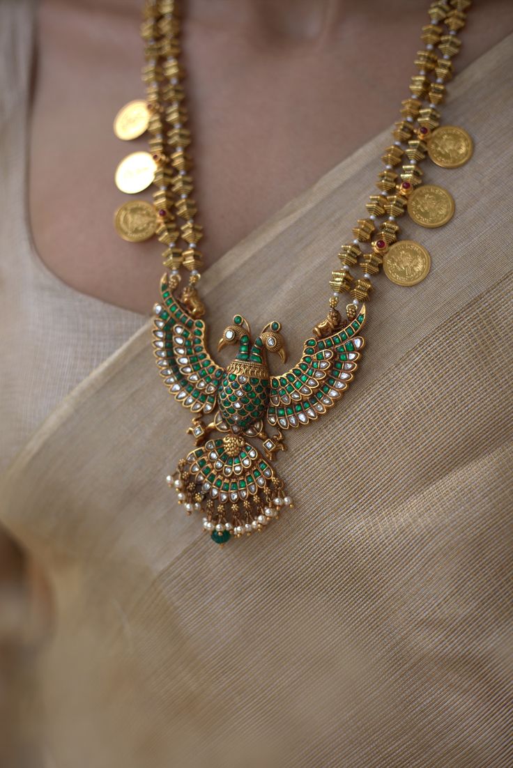ANTIQUE GOLD NECKLACE WITH BIRD DESIGN AND COIN PENDANTS.